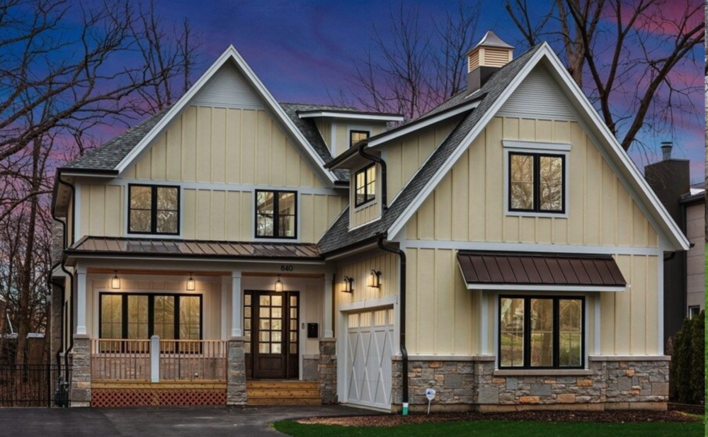 A large house with a lot of windows and a porch