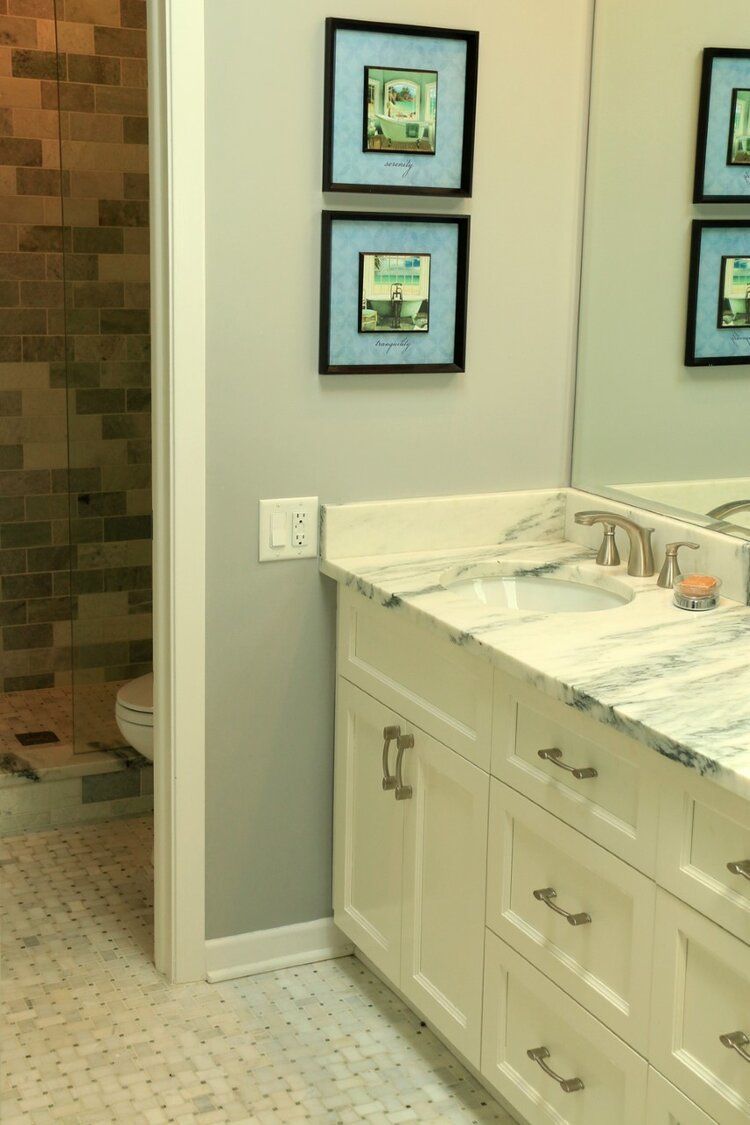 A bathroom with a sink , mirror and toilet.
