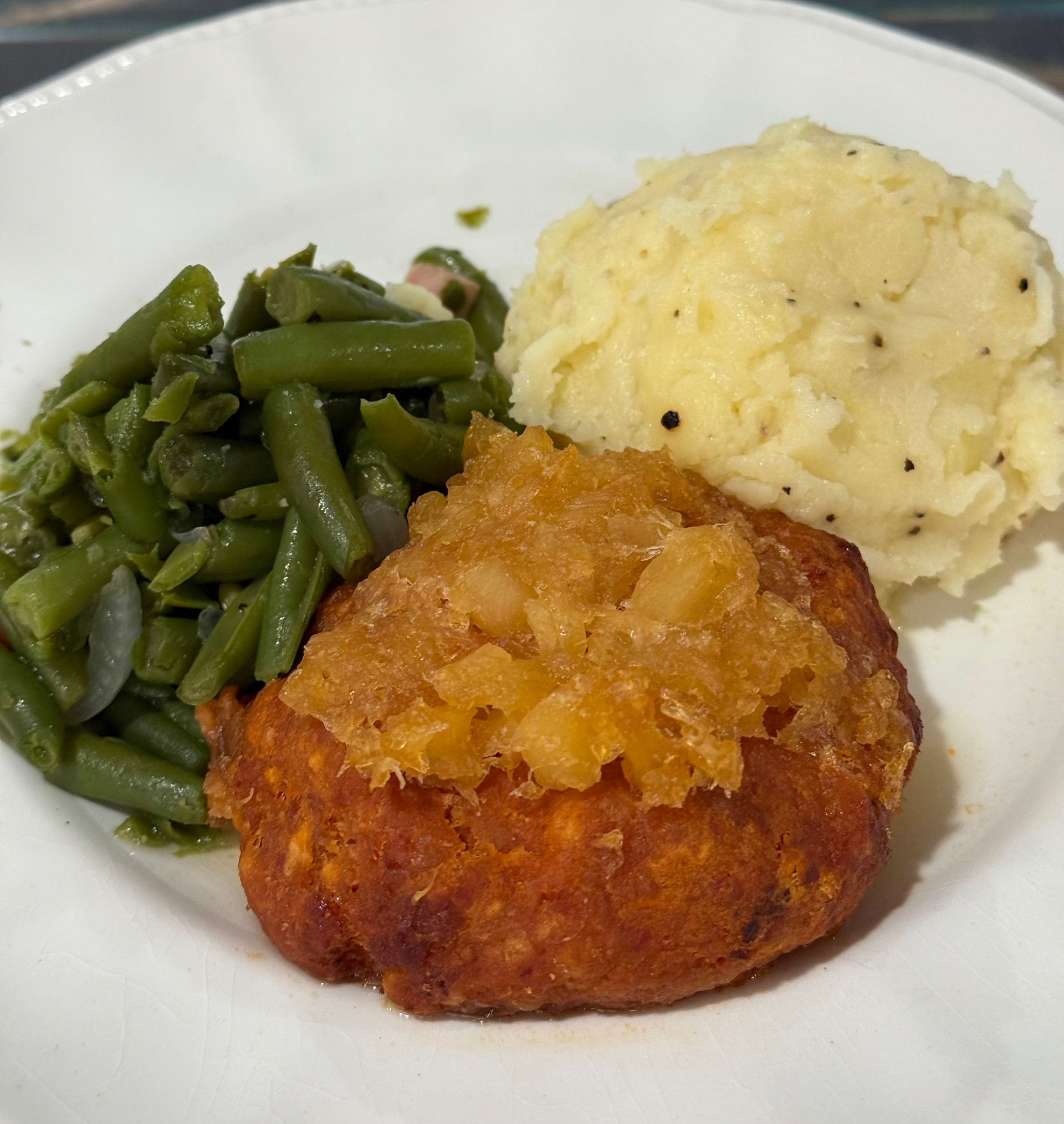 A styrofoam container filled with macaroni and cheese and coleslaw.