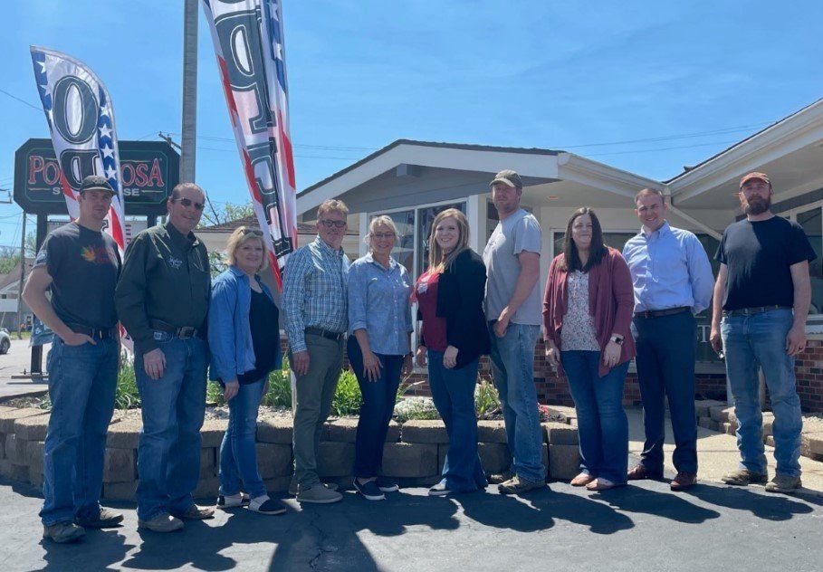 A group of people are standing in front of a building.