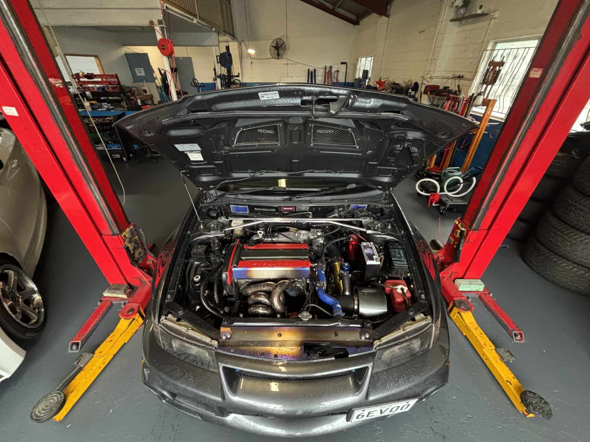 Car Bonnet Up Whilst On Hoist — Triple C Workshop in Springwood, QLD