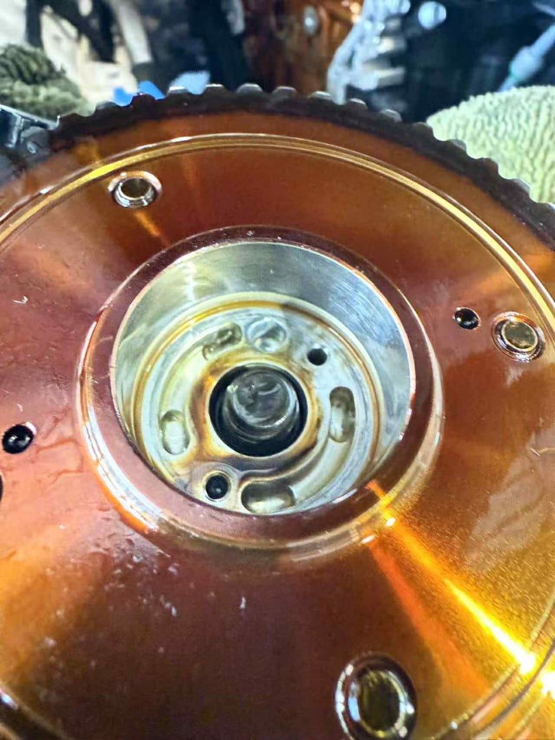 Close-Up of A Gold-Colored Automotive Camshaft Gear Showing Internal Components and Bolt — Triple C Workshop in Springwood, QLD