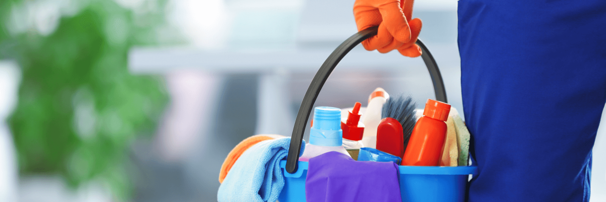 Professional cleaner holding a bucket of cleaning supplies