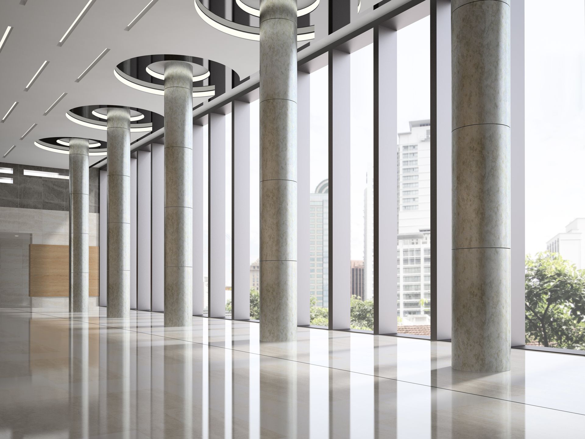 A large empty room with a lot of windows and columns.