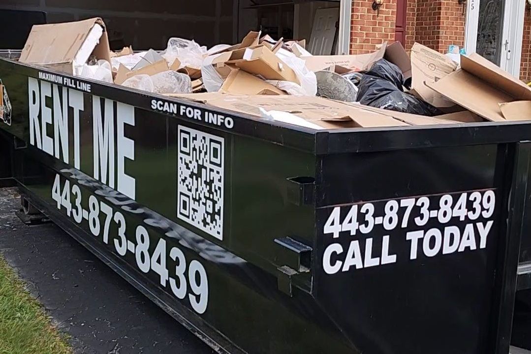 a 10 yard dumpster with a concrete slab in it is sitting on the side of the road .