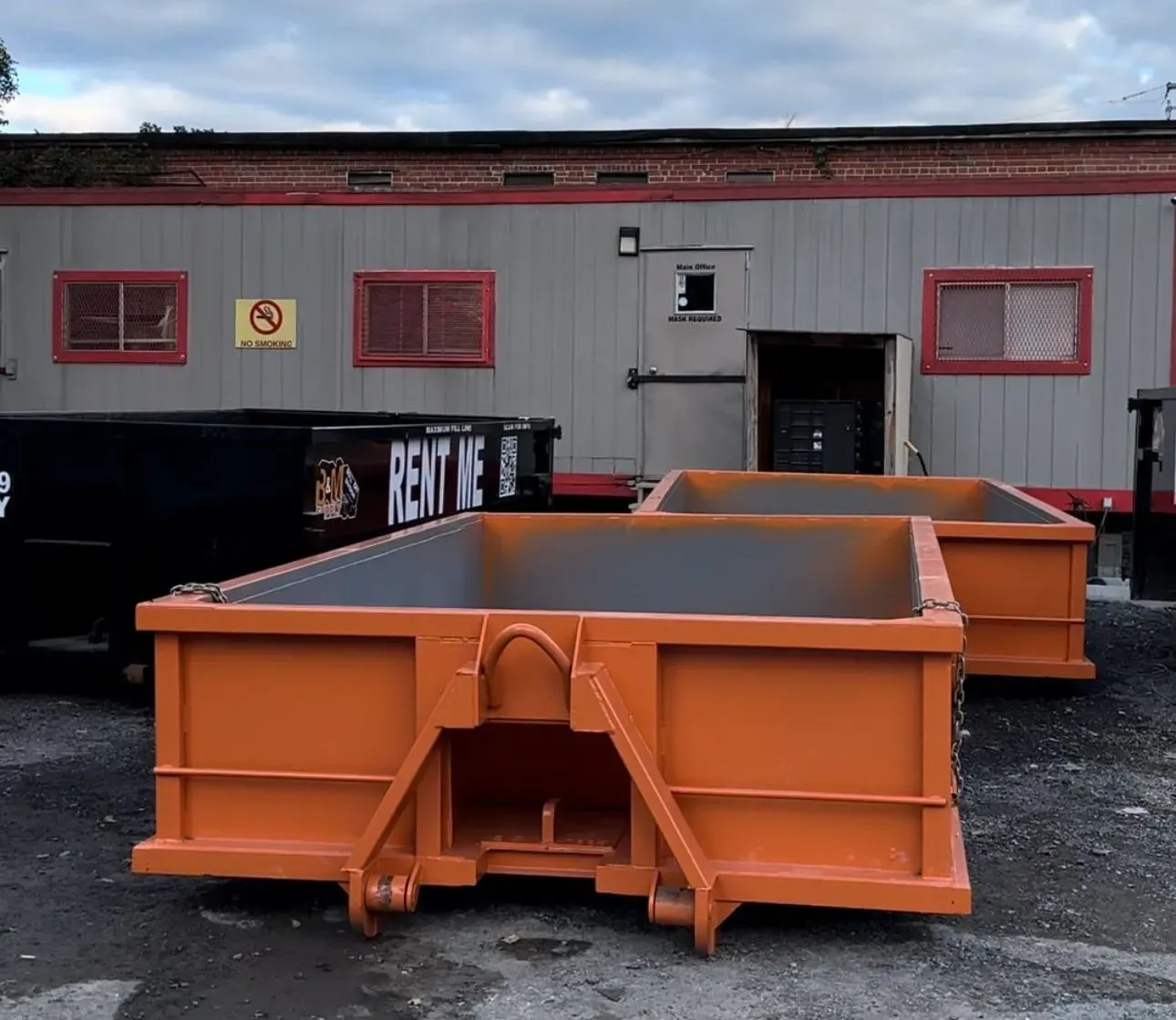 a 10 yard dumpster with a concrete slab in it is sitting on the side of the road .