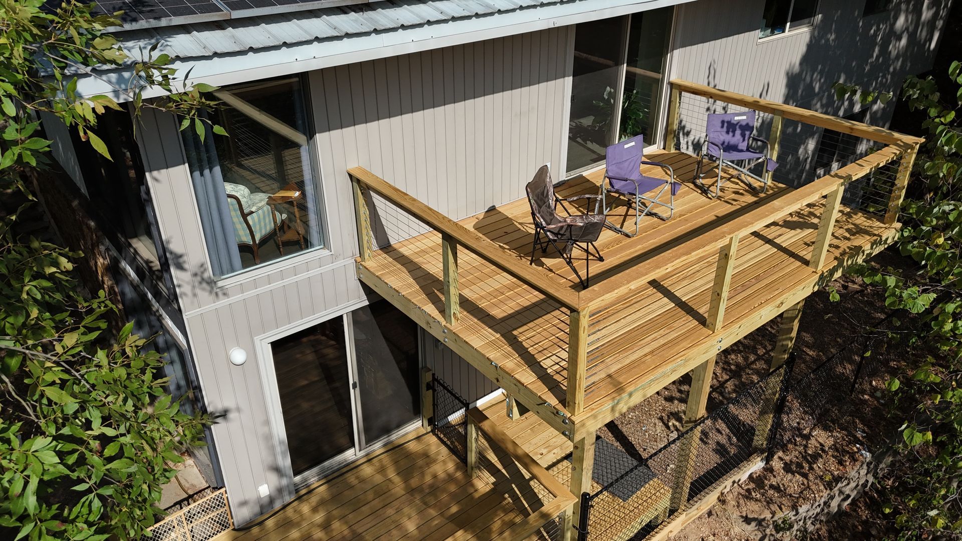 An aerial view of a house with a wooden deck