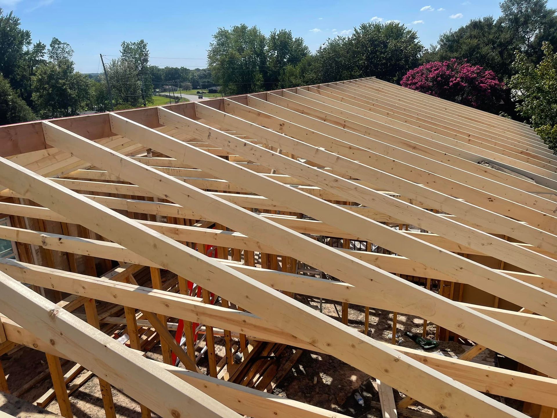 The roof of a house is being built with wooden beams.