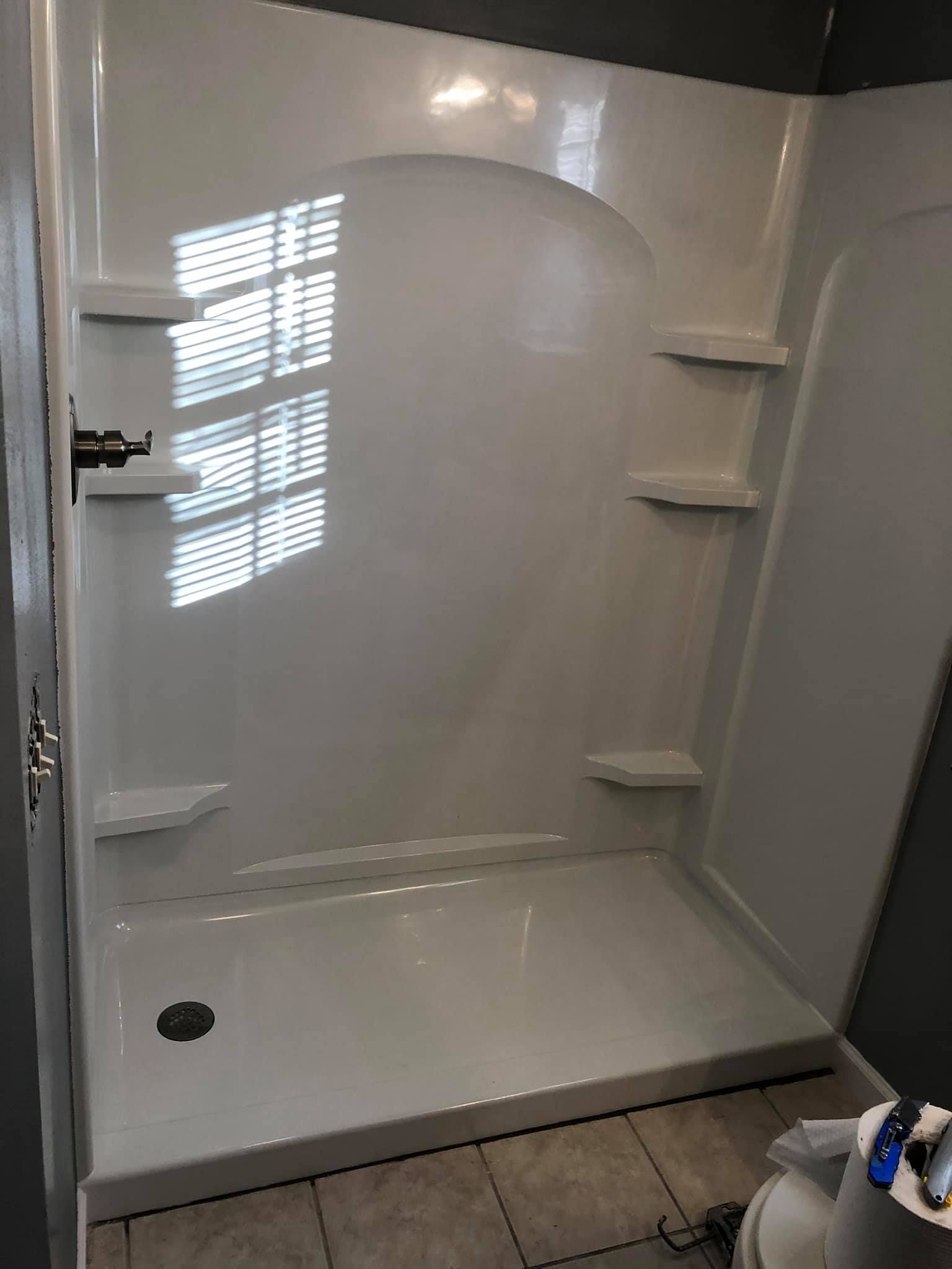 A bathroom with a walk in shower and a toilet.