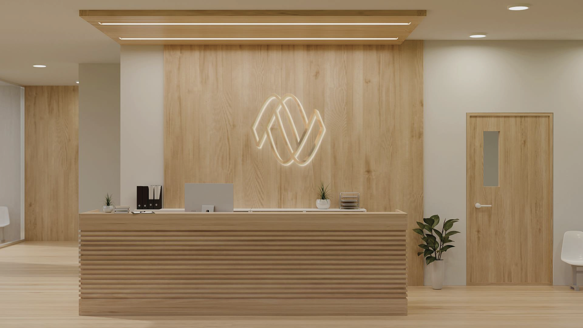 A reception desk in a hospital with a wooden wall and a logo on it.