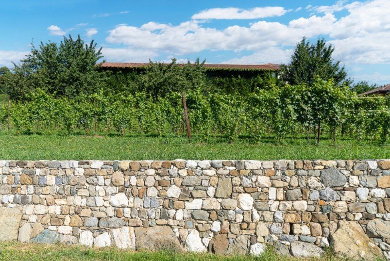 Stone wall, Green Grass — Capital Fencing in Queanbeyan, NSW