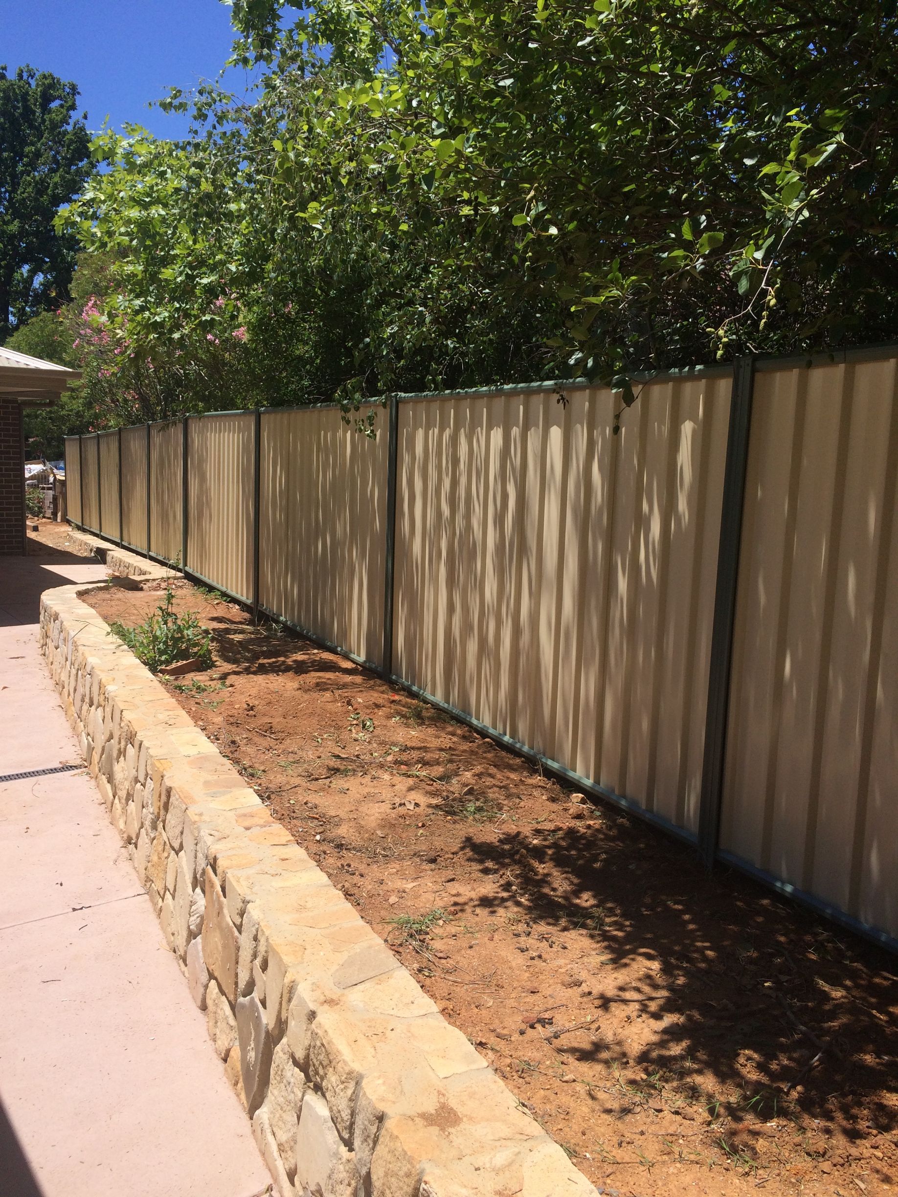 Colorbond Fencing on top of a retaining wall — Capital Fencing in Charnwood, ACT