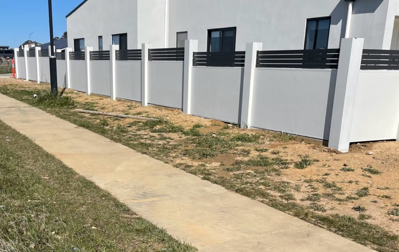 White Concrete Wall With Black Fencing — Capital Fencing in Charnwood, ACT
