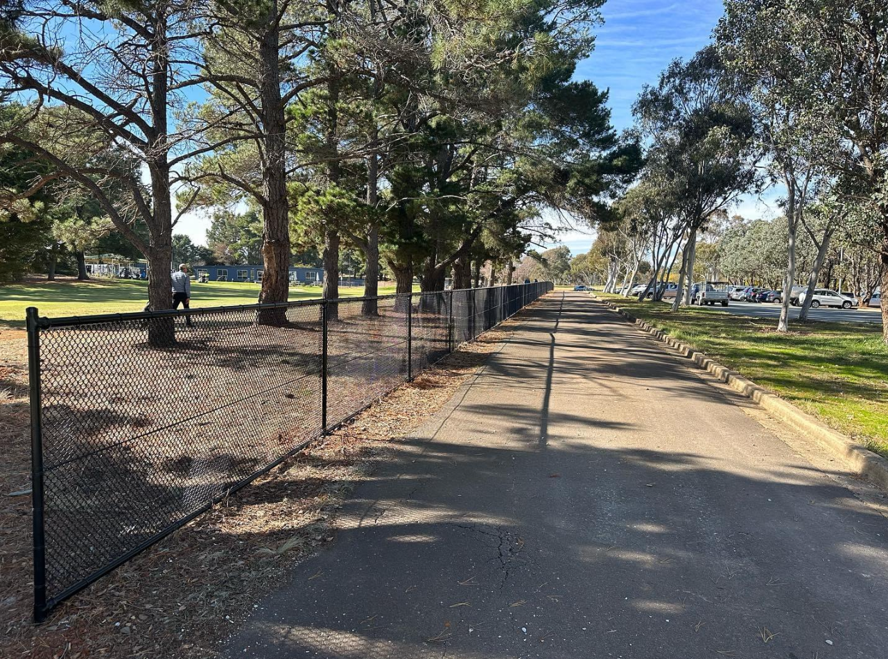 Chain-wire Fence Along A Path With a Chain-wire Gate— Capital Fencing in Charnwood, ACT