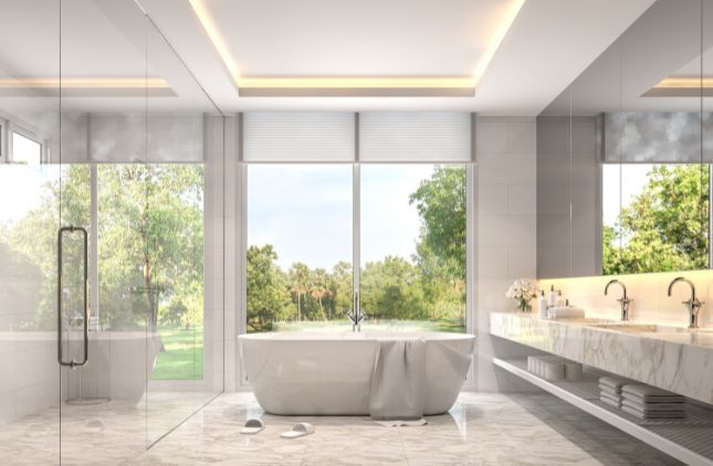 Modern bathroom with white vanity, sinks, mirrors, and a shower/tub combo.