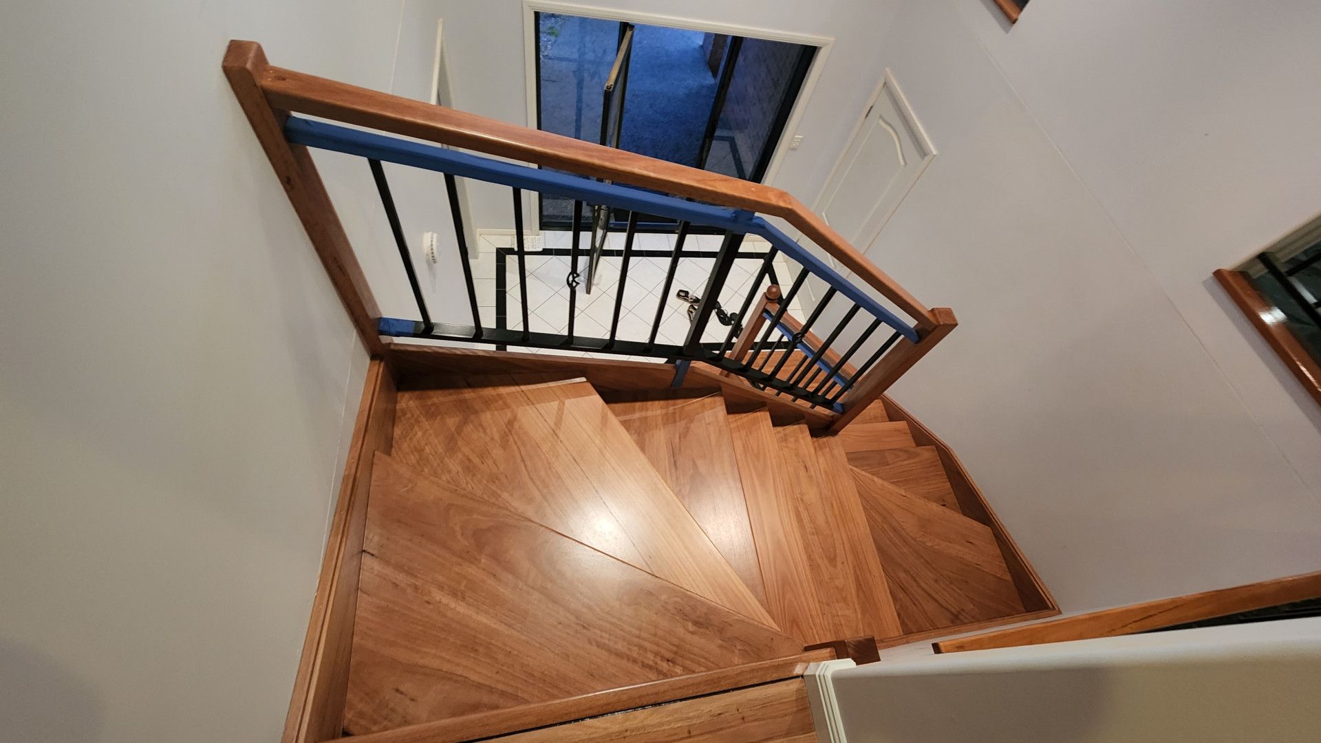 A Staircase With a Glass Railing and Wooden Steps — Shane Callinan Floor Sanding In North Haven, NSW