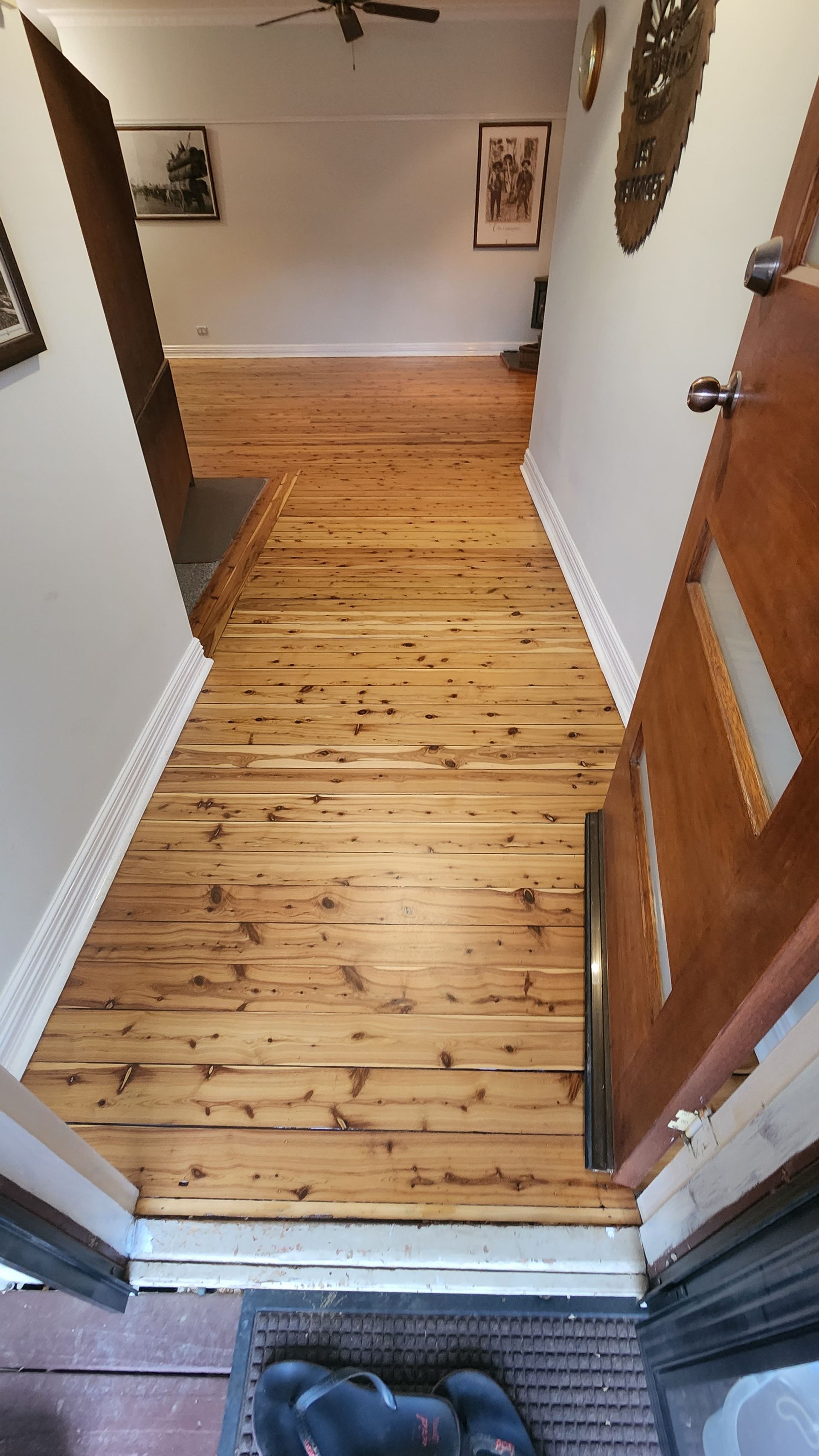 A Corner of a Room With a Wooden Floor and White Trim — Shane Callinan Floor Sanding In North Haven, NSW