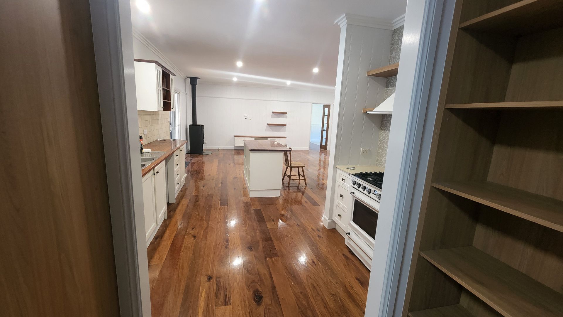 A Living Room With a Couch , Chairs , Coffee Table and Rug — Shane Callinan Floor Sanding In North Haven, NSW