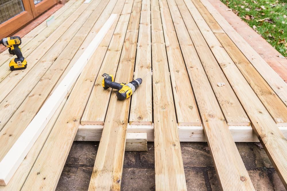 Two Drills Are Sitting on Top of a Wooden Deck — Shane Callinan Floor Sanding In North Haven, NSW