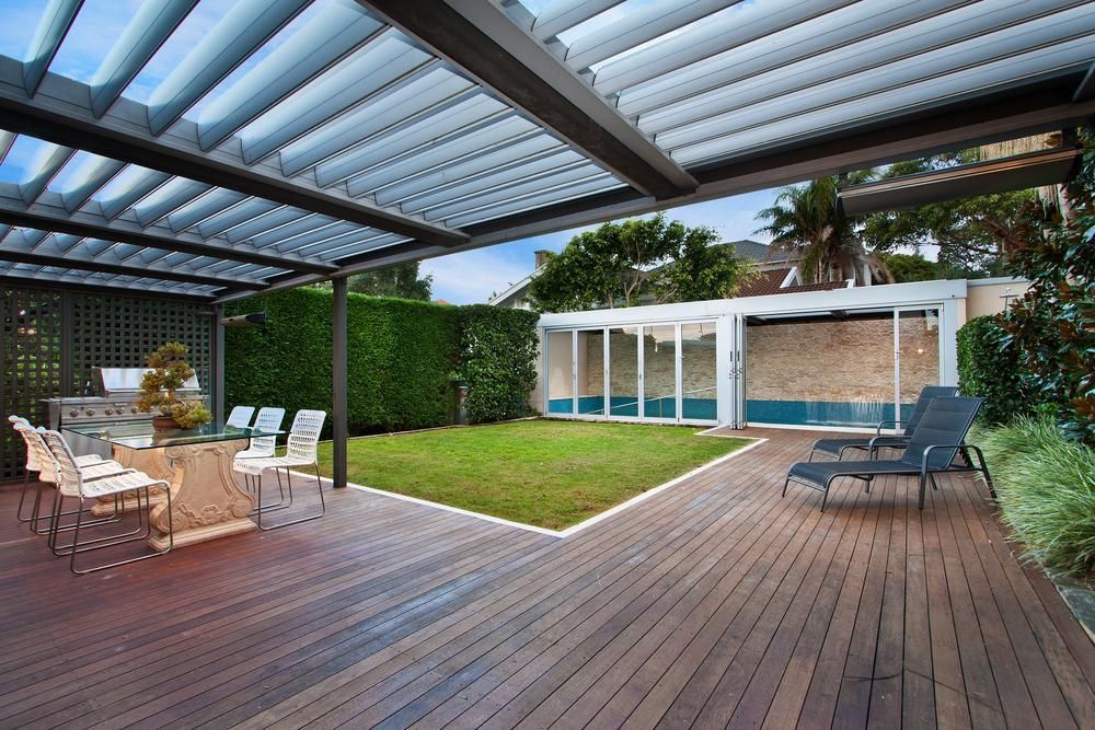 A Large Wooden Deck With a Pergola Over It — Shane Callinan Floor Sanding In Lake Cathie, NSW