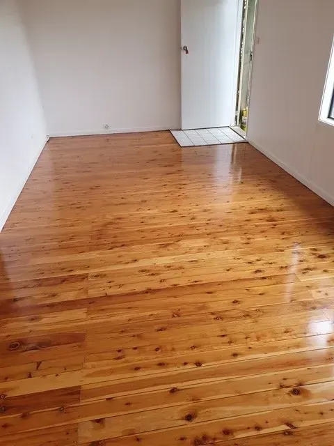 A Room With a Wooden Floor and White Walls — Shane Callinan Floor Sanding In Port Macquarie, NSW