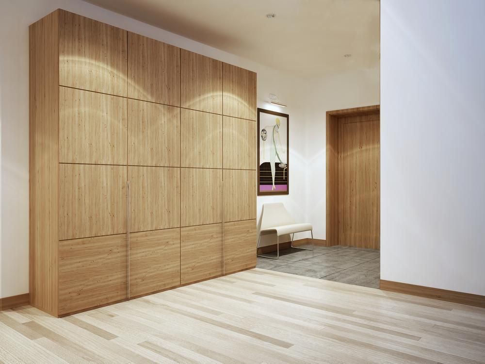 A Hallway With Wooden Cabinets , a Chair , and a Door — Shane Callinan Floor Sanding In Thrumster, NSW