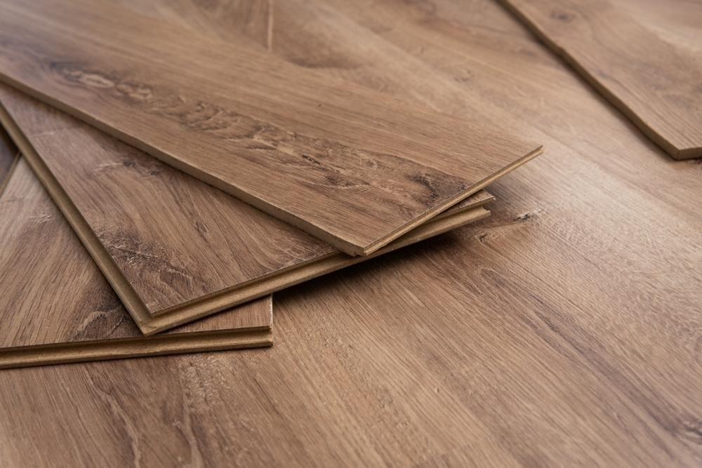 A Flooring Boards Stacked on Top of Each Other on a Wooden Floor — Shane Callinan Floor Sanding In South West Rocks, NSW