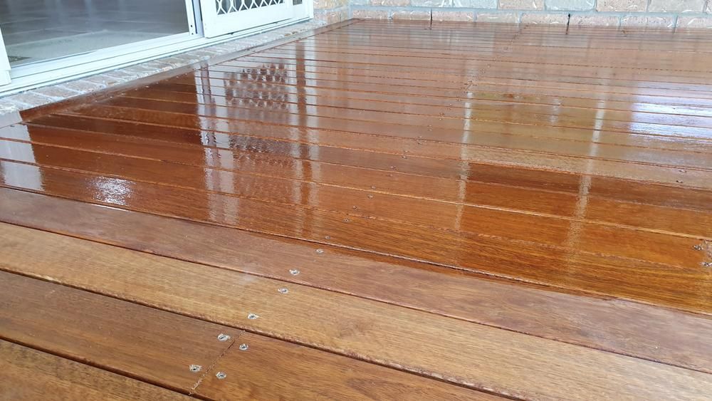 A Close Up of a Wooden Deck With a Reflection of a Window — Shane Callinan Floor Sanding In Lake Cathie, NSW