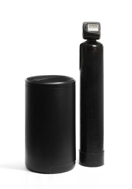 Residential water softening equipment with water softener and brine tank for home water treatment.