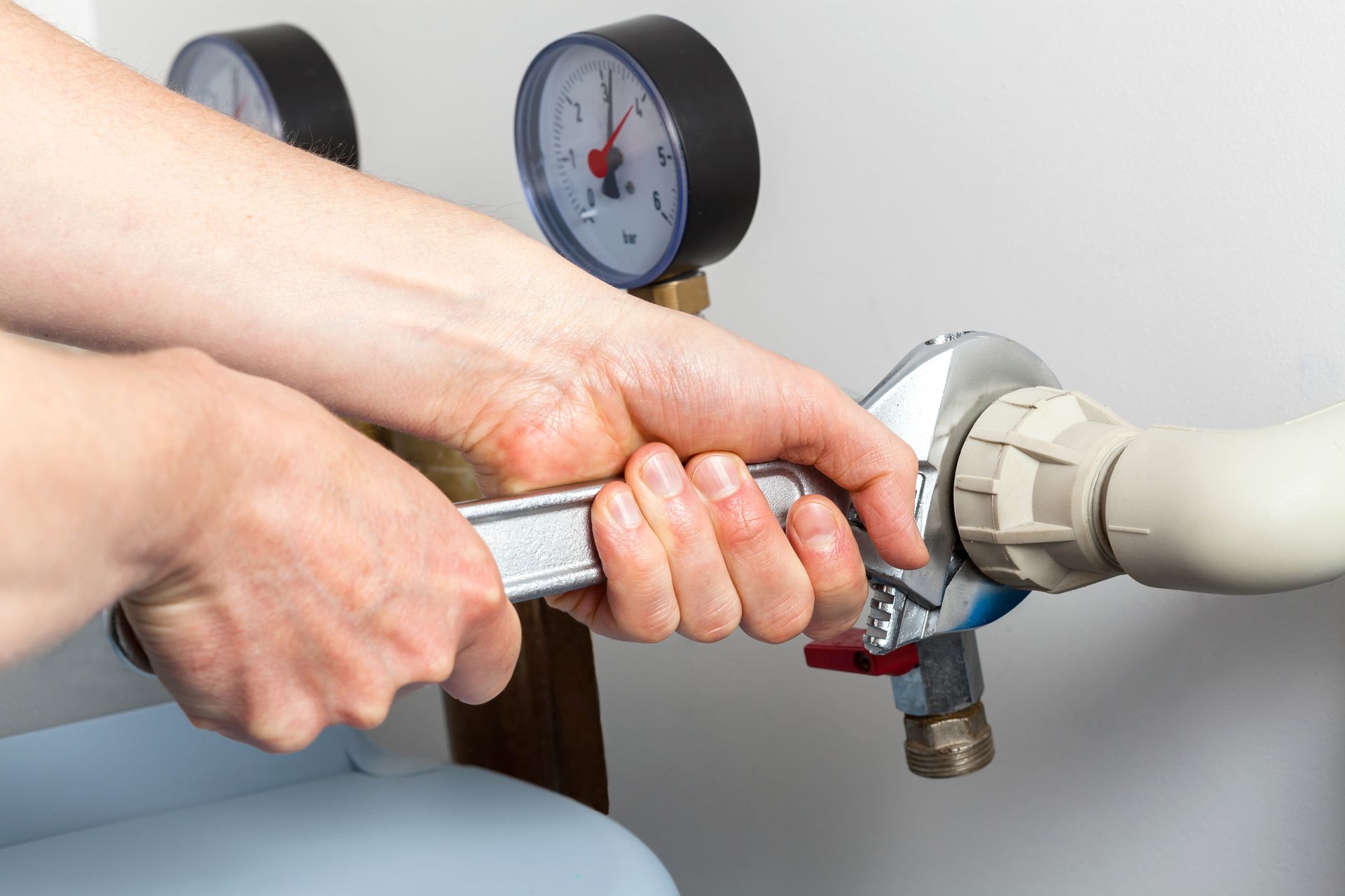 Close-up of a person holding a wrench.
