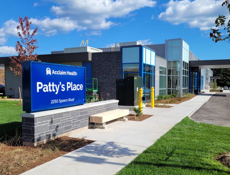 A building with a sign that says patty 's place in front of it.