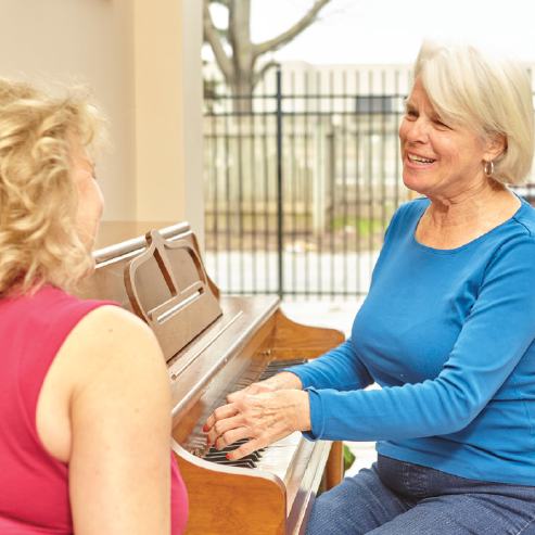 Adult Day Program participant learning to play on a piano