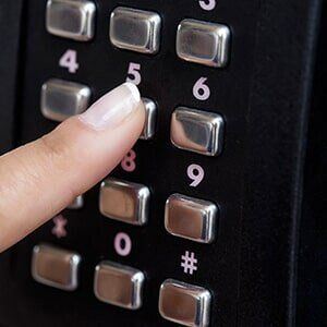 person touching keys on numbered keypad