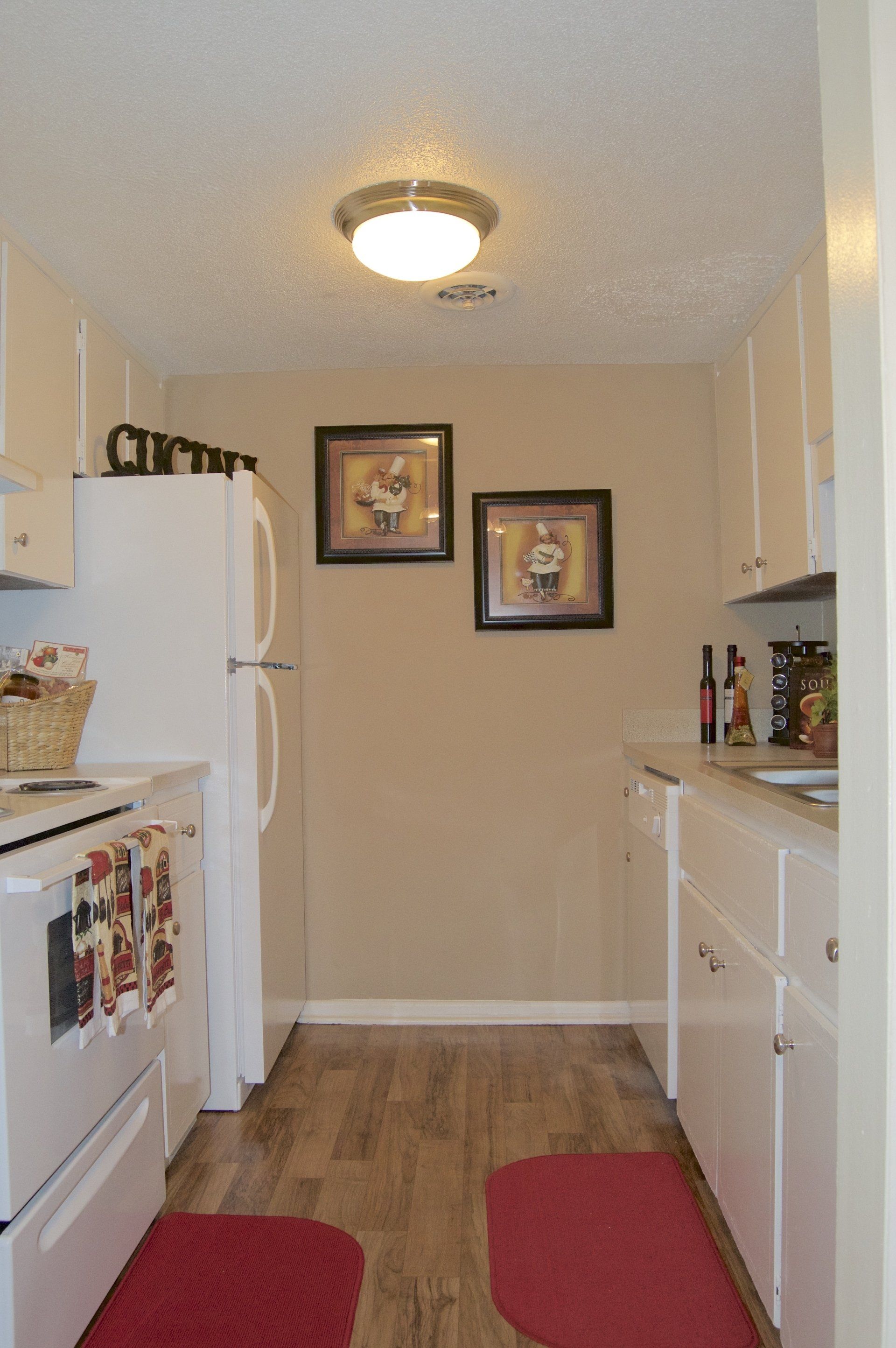 Apartment Kitchen with Fridge and White Cabinet | Cambridge Apartments