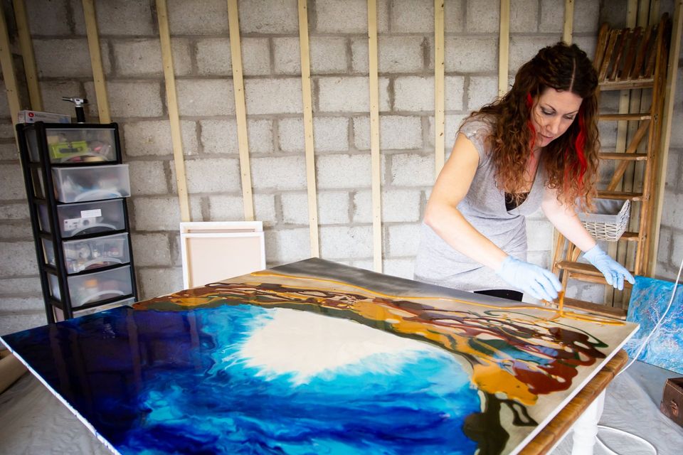 Celia Lancaster creating a large resin art painting