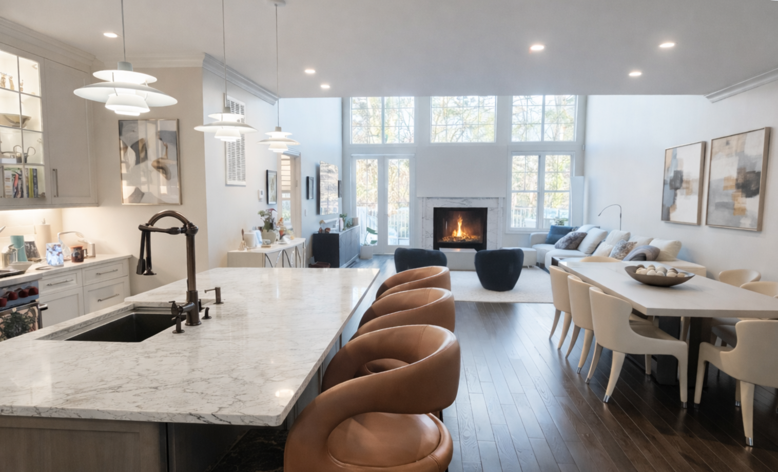 Woman with light brown hair, wearing a black top and silver earrings, looking toward the viewer.