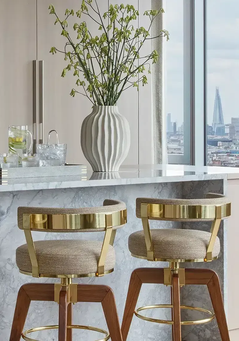 Living room with two cream-colored sofas facing each other, a fireplace, and artwork on the walls.