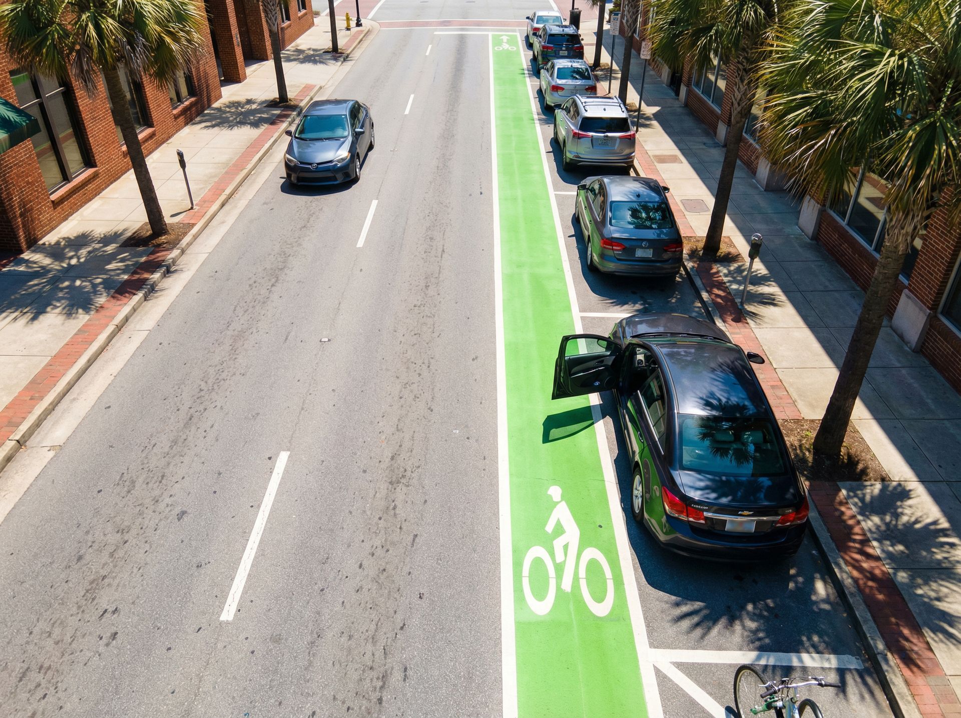 Cyclist injured in Athens Georgia bicycle accident with damaged bike on road
