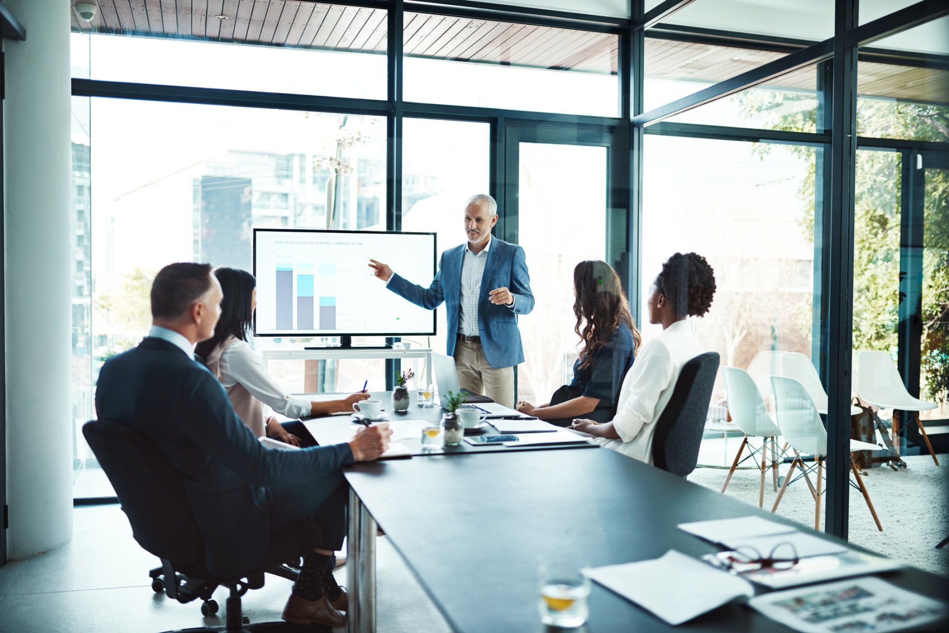 A man is giving a presentation to a group of people in a conference room - Baton Rouge, LA - Coastal Environments, Inc.