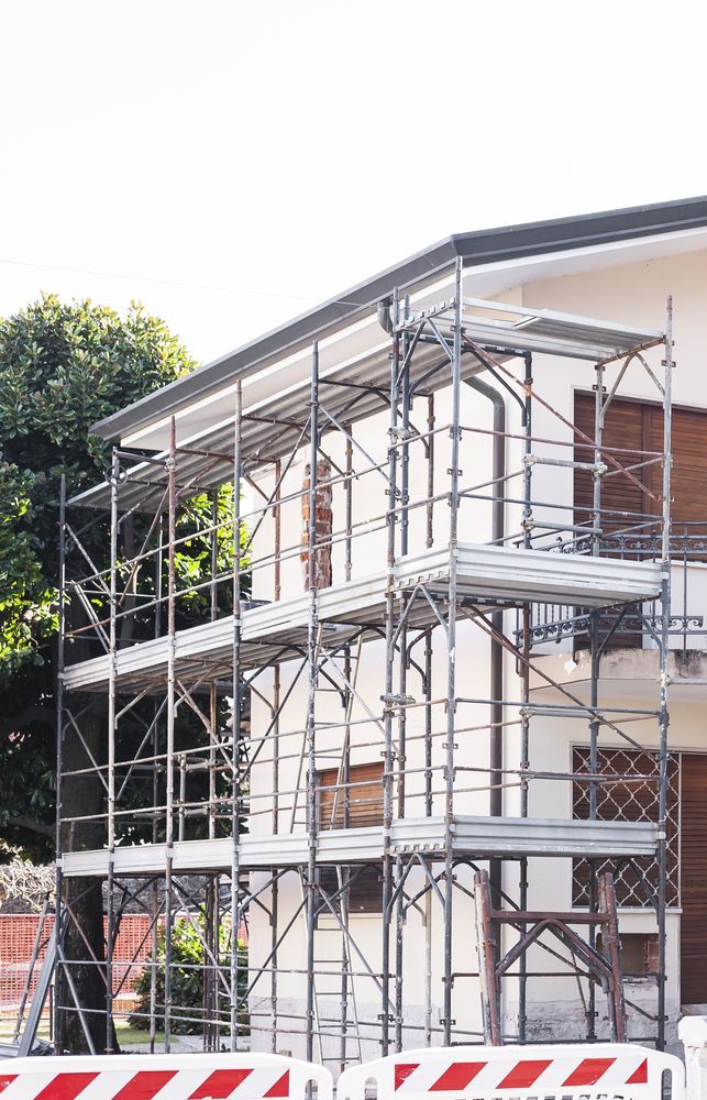 Scaffolding on the Side of a White Building for Construction — Iconic Construction Industries in Brisbane, QLD