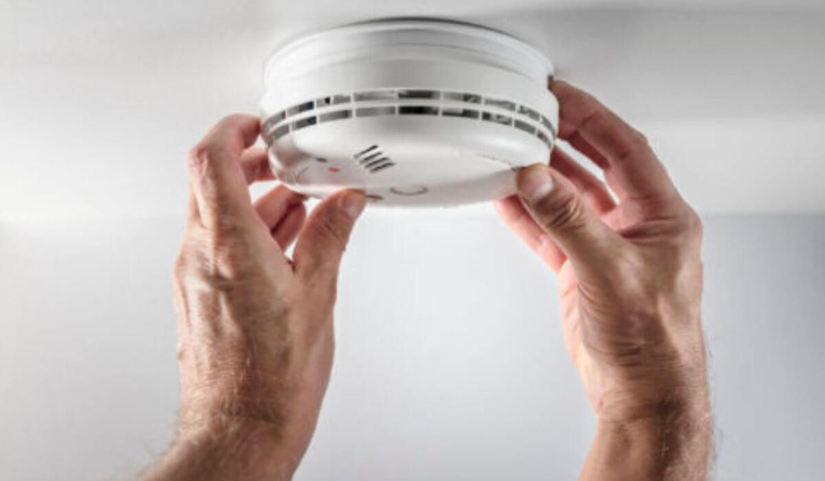 family checking fire alarm