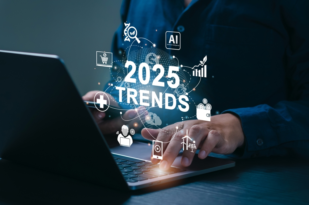 A laptop with the words 2025 trends coming out of the screen.