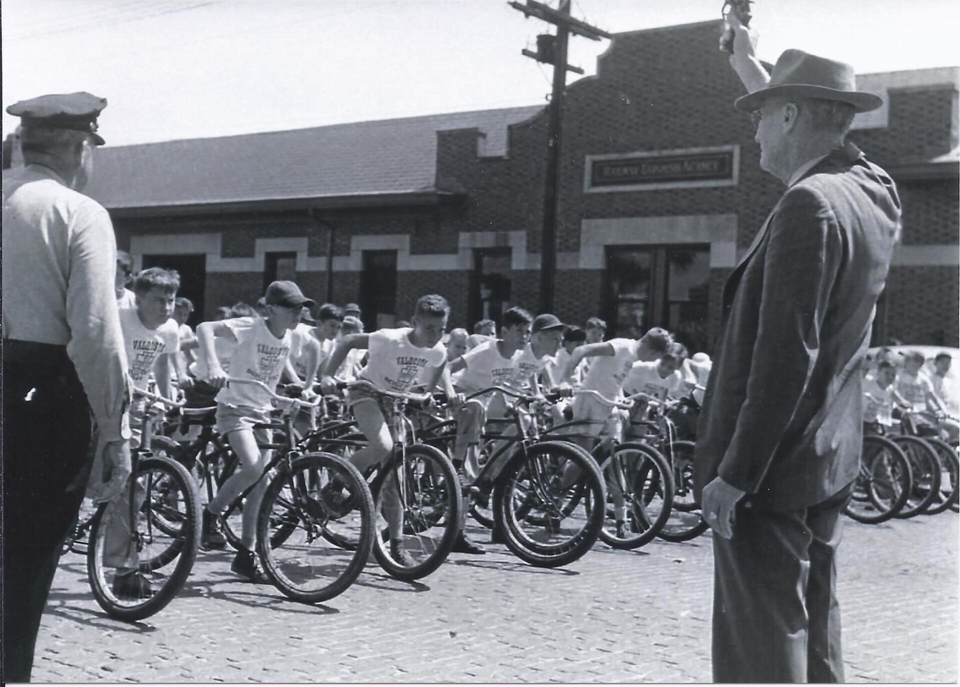 Historic 1949 photo of boys lined up with bicycles outside Boys & Girls Club building