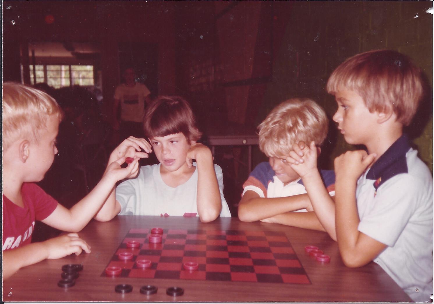 1990s photo of kids at Boys & Girls Club playing checkers indoors