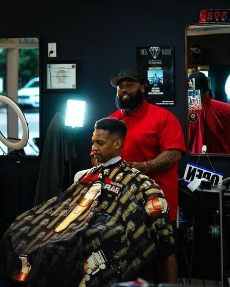 Man with a flattop getting a haircut