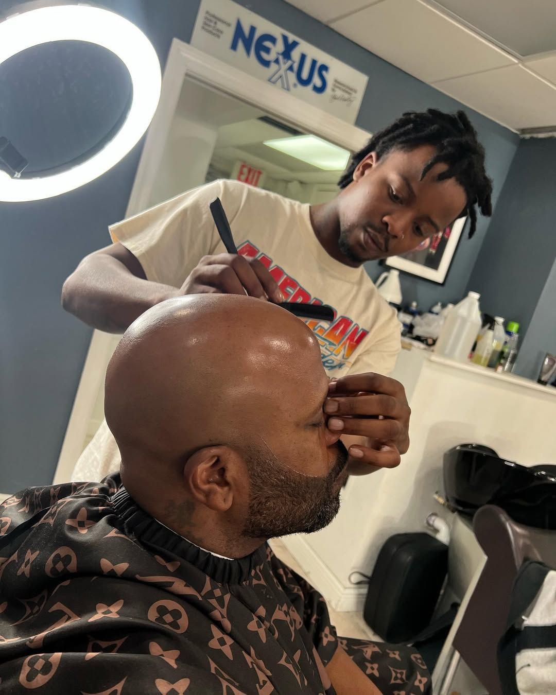 Man getting a beard trim with a straight razor