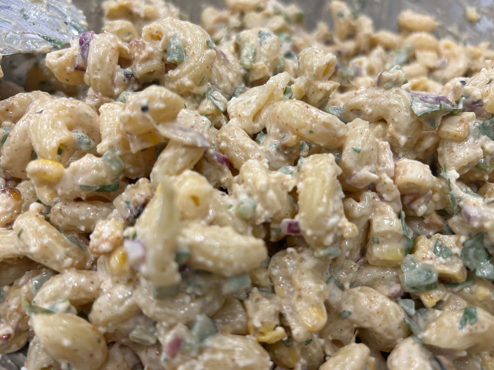 Macaroni salad with pasta, vegetables, and creamy dressing.