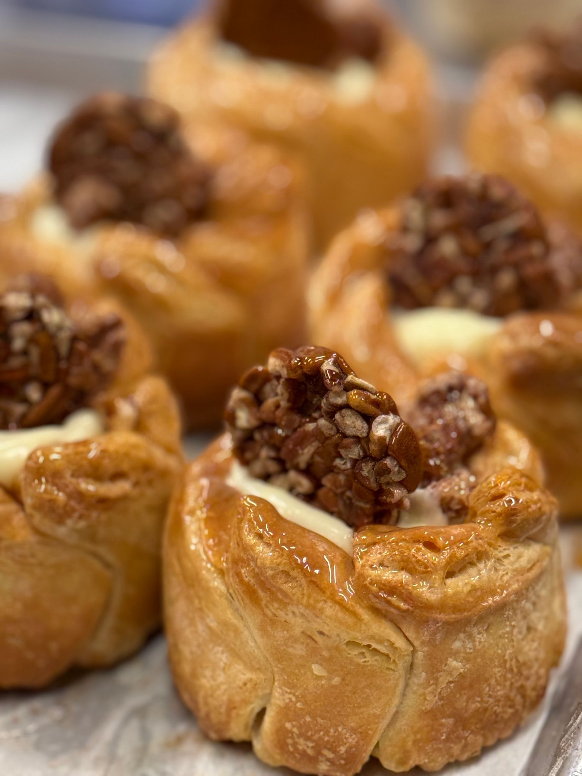 Pastries with creamy filling and candied pecans.
