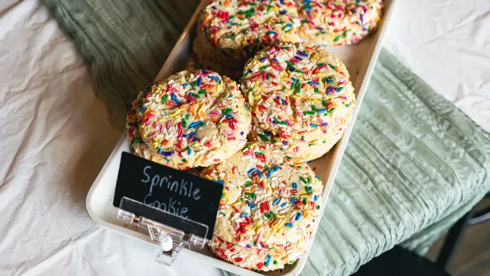 Sprinkle cookies on a white platter with a handwritten 