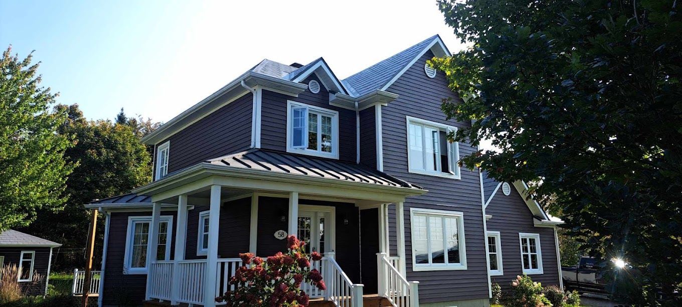 A large house with a porch and a lot of windows